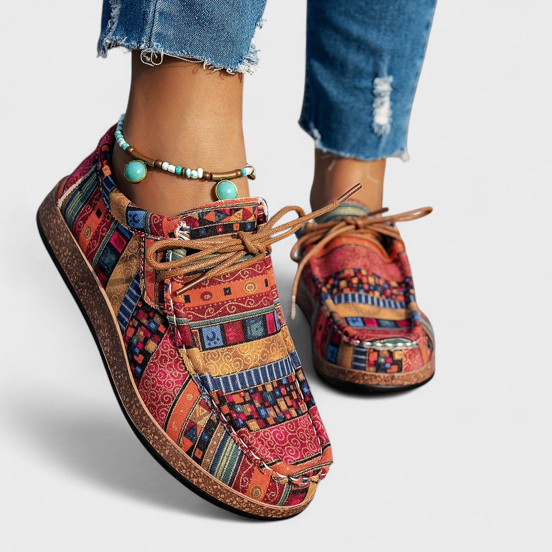 Amelia wearing orthopaedic sneakers for women with patchwork textile upper and wide supportive sole