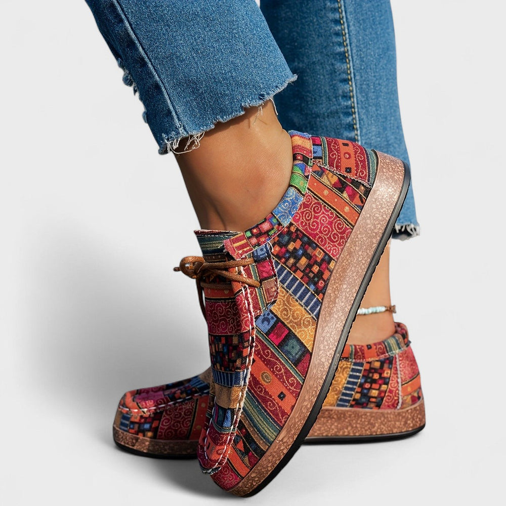 Close-up view of orthopaedic sneakers for women showing lace-up closure and multicoloured patchwork design