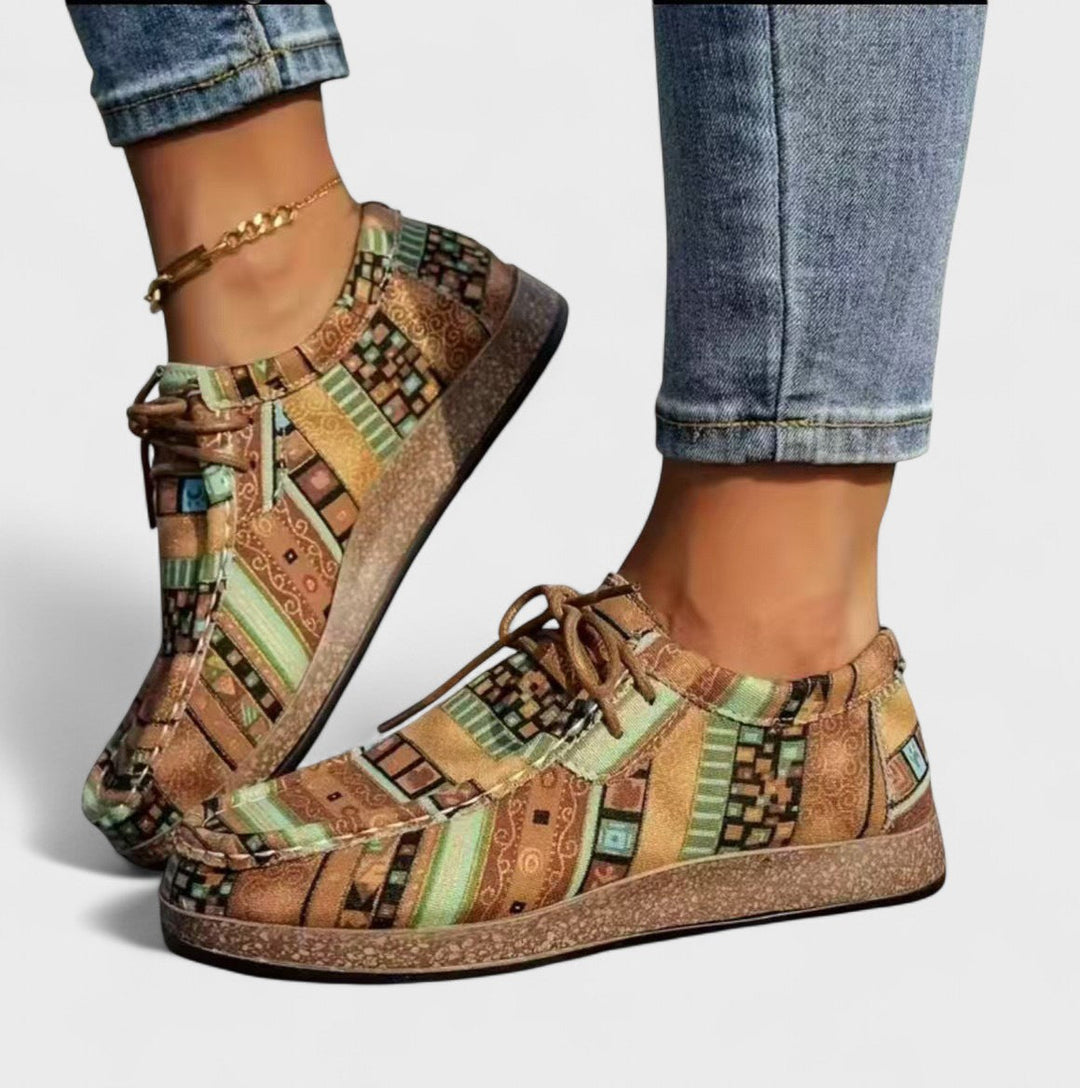 Side profile of women's orthopaedic trainers with cushioned footbed and textured platform base