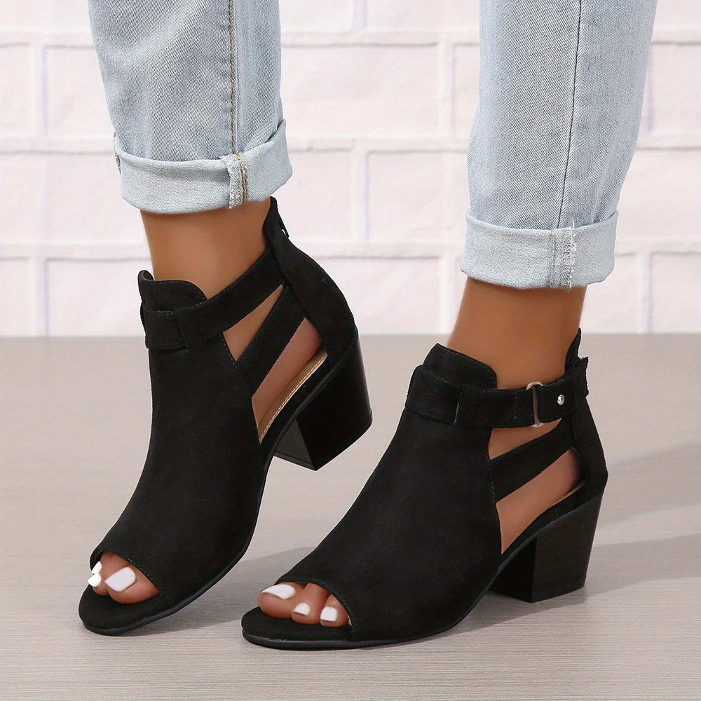 Close-up view of women's block heel sandals showing cut-out ankle detail and stacked heel construction