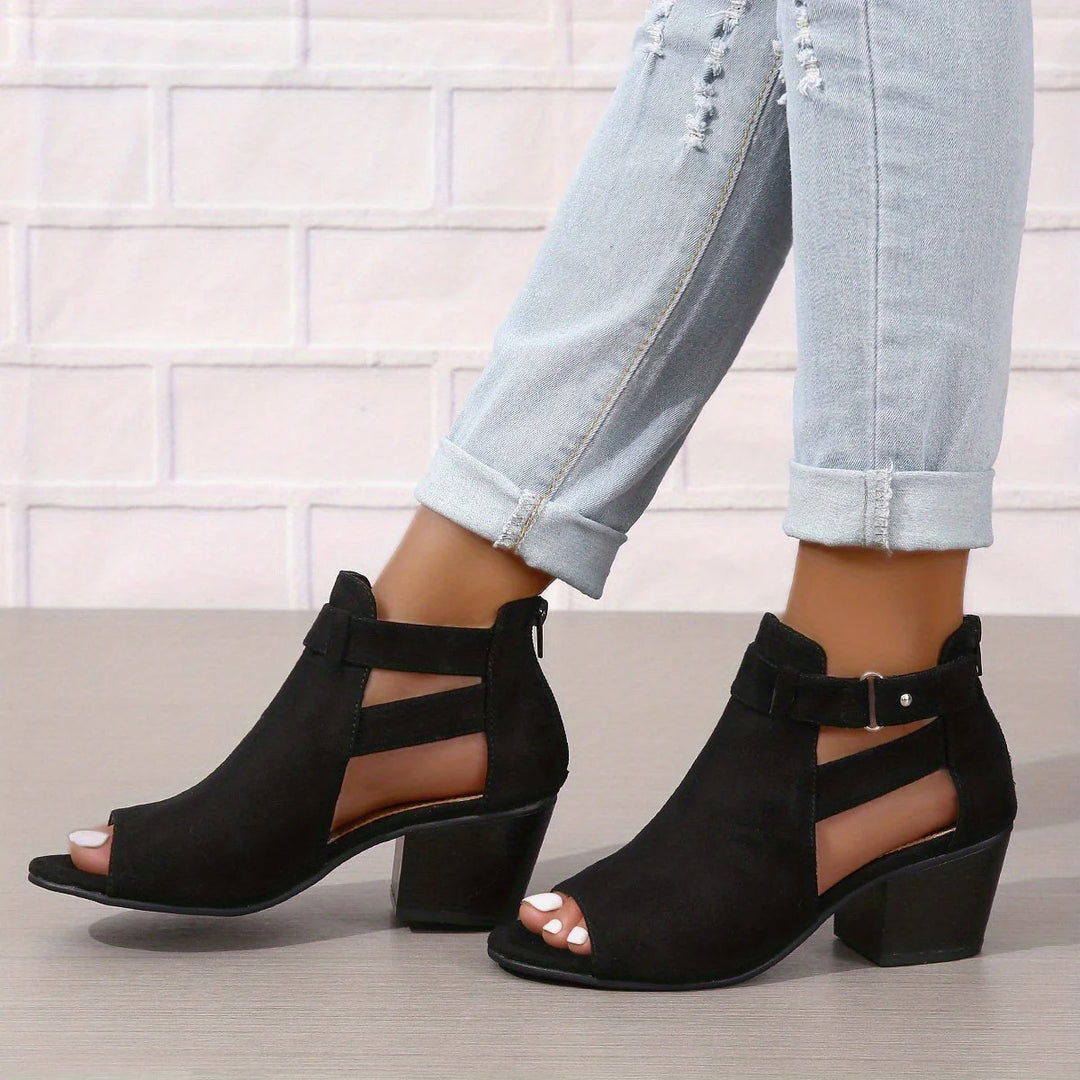 Women's block heel sandals worn with rolled-up jeans showcasing peep toe and ankle strap