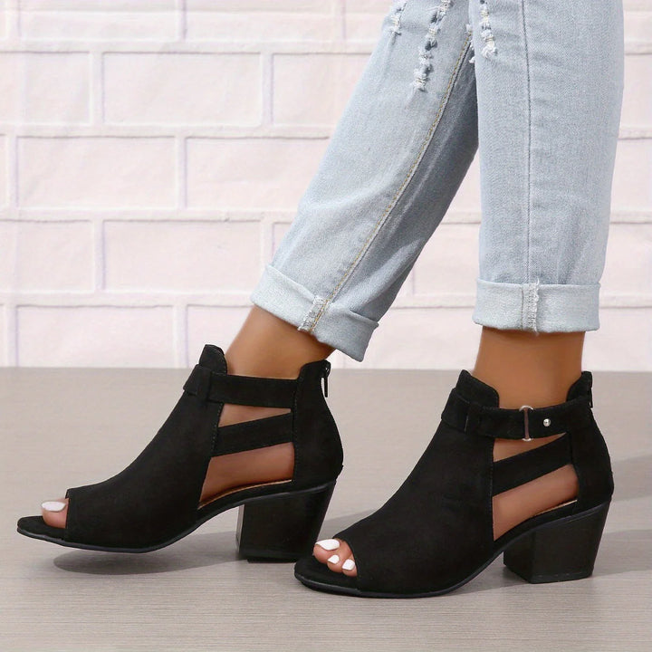 Women's block heel sandals worn with rolled-up jeans showcasing peep toe and ankle strap