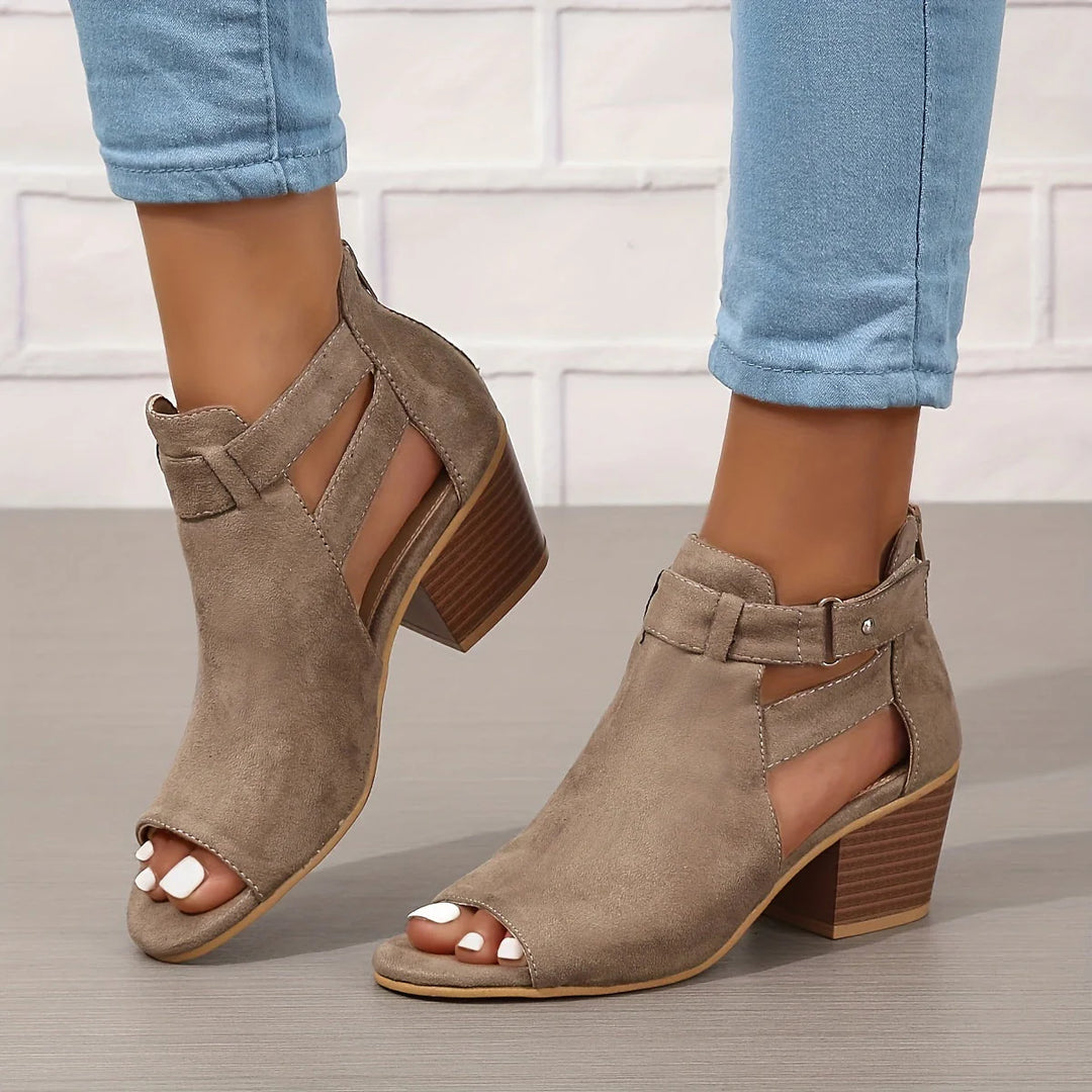 Detailed view of stacked block heel and cut-out upper on women's sandals