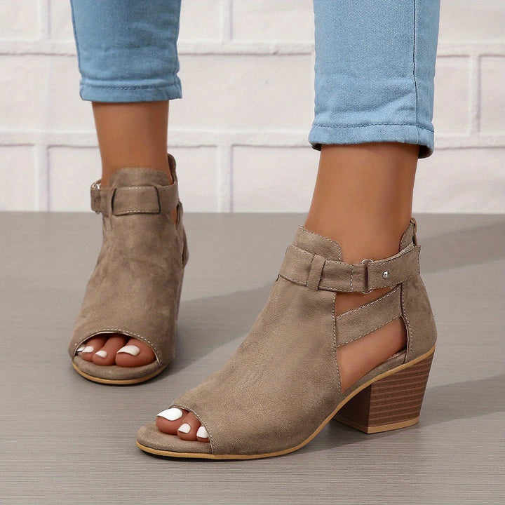 Women's block heel sandals from behind showing ankle strap closure and heel height