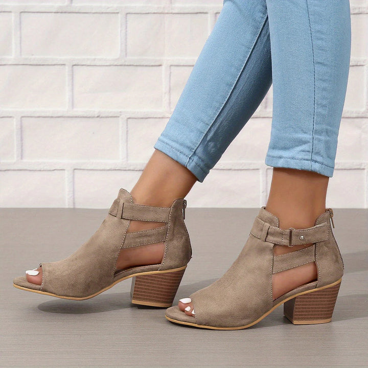 Front view of women's block heel sandals highlighting peep toe opening and buckle detail