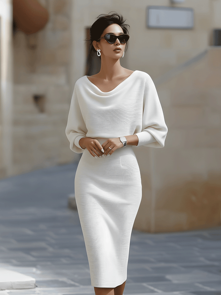 Woman wearing a white Women's Boat Neck Batwing Sleeve Midi Bodycon Dress with ribbed knit fabric and relaxed batwing sleeves