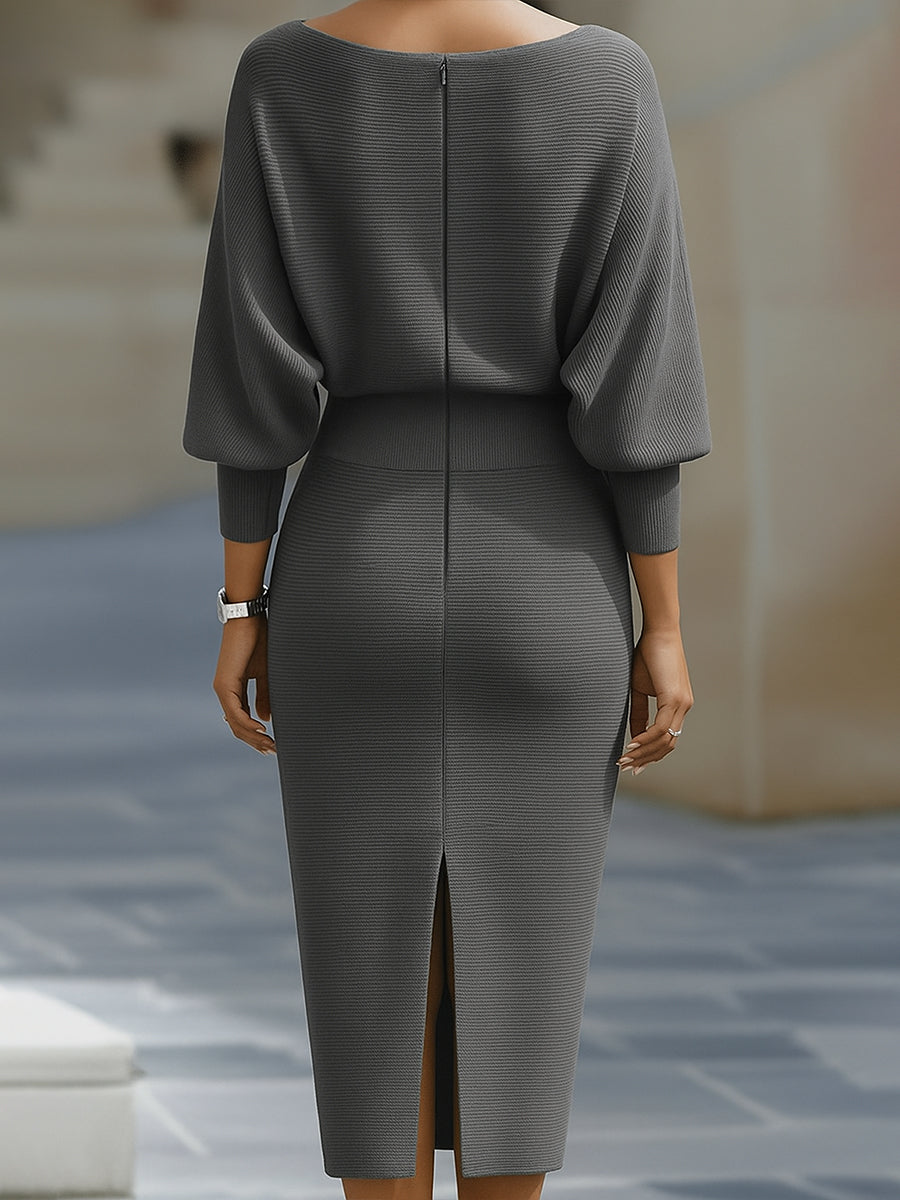Detail showing the relaxed batwing sleeves and structured bodycon fit of the dress
