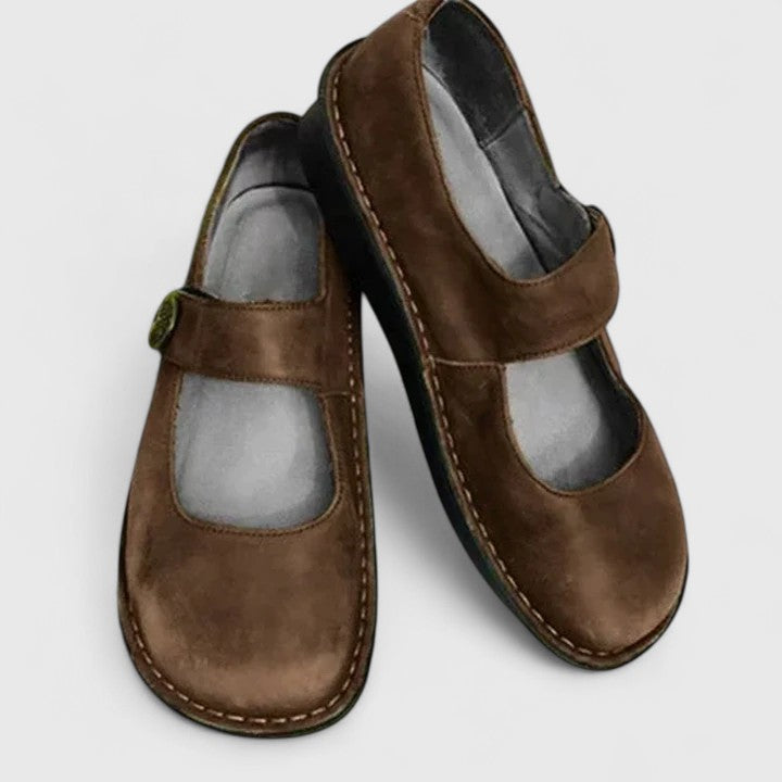 Close-up of Mary Jane loafers showing rounded toe and metal buckle closure