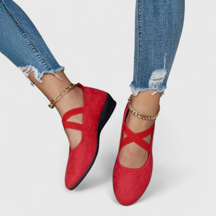 Overhead view of black orthopedic cross strap shoes with elastic straps and structured upper on model