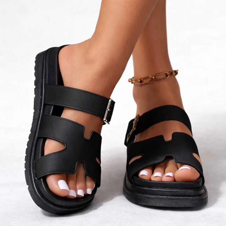 Women's platform sandals in black with contoured footbed and adjustable ankle buckle strap