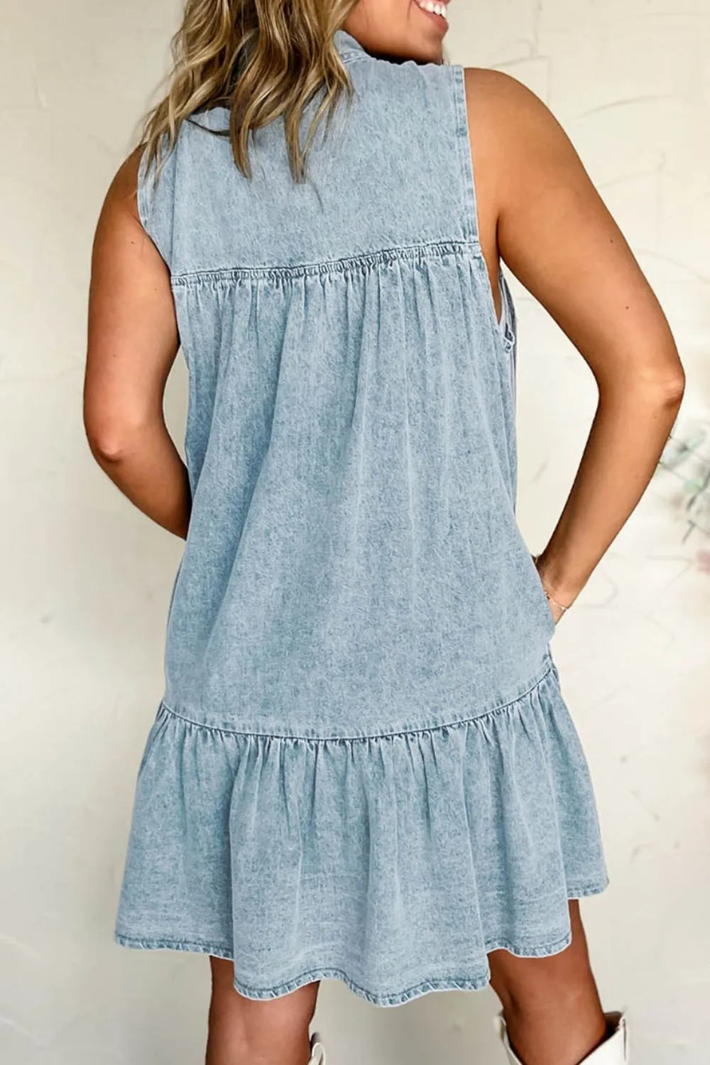 Close-up view of bow tie neckline detail on chic summer dress with gathered tiers