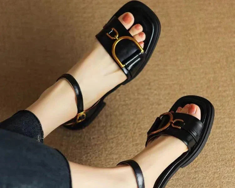 Side profile of flat sole women's leather sandals with structured upper and ankle fastening