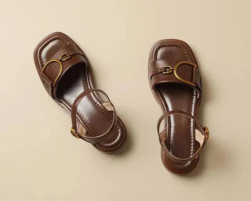 Pair of women's buckled leather sandals showing square toe shape and adjustable ankle straps
