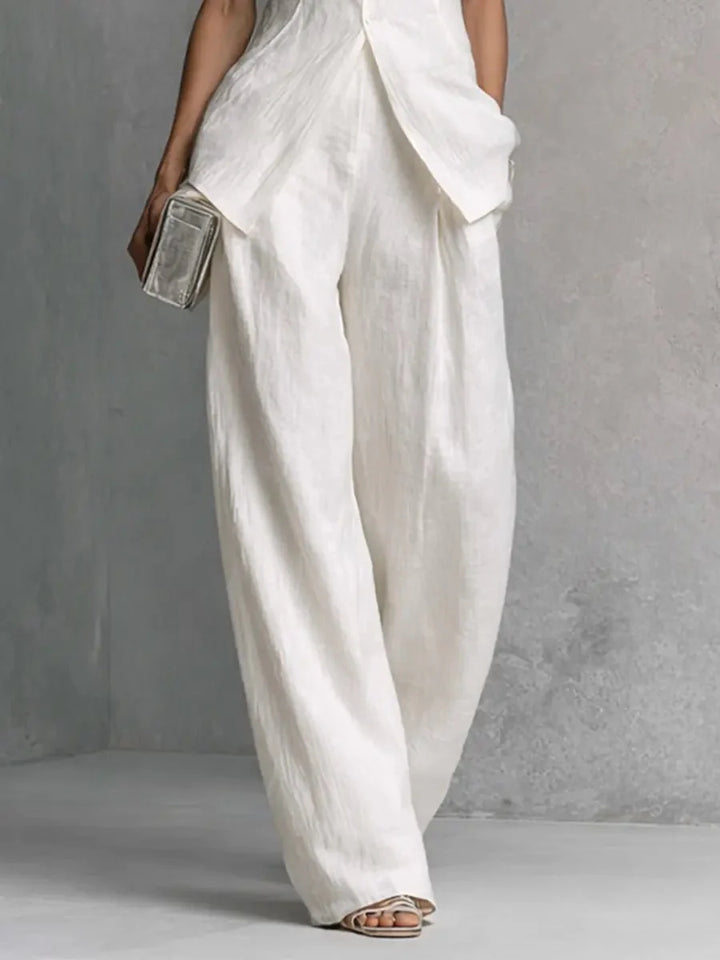 Back view of Women's Cotton-Linen Stand-Collar Wide-Leg Two-Piece Set showing high-low hemline and trouser drape