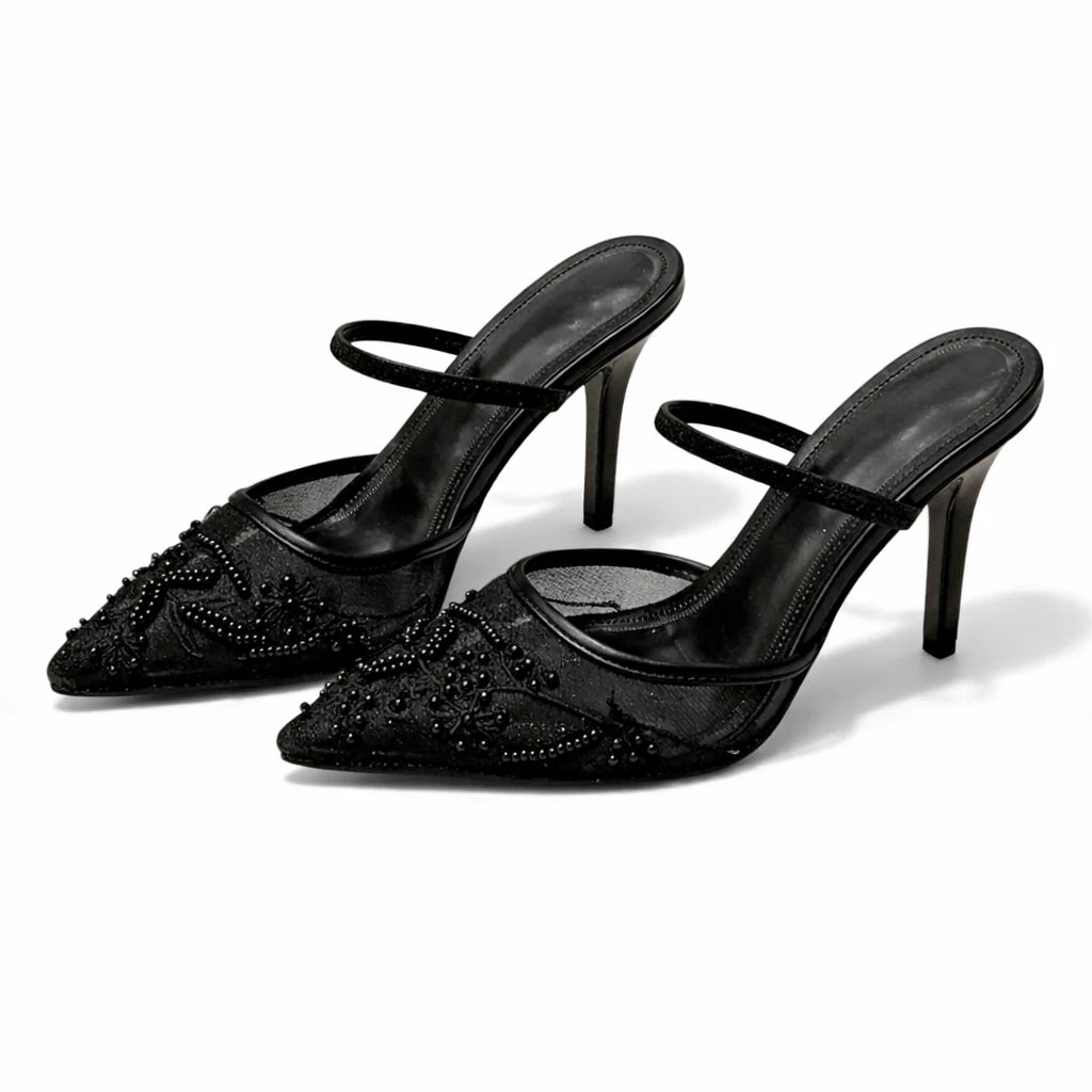 Detail shot of floral embroidery on mesh mule heels with pointed toe shape
