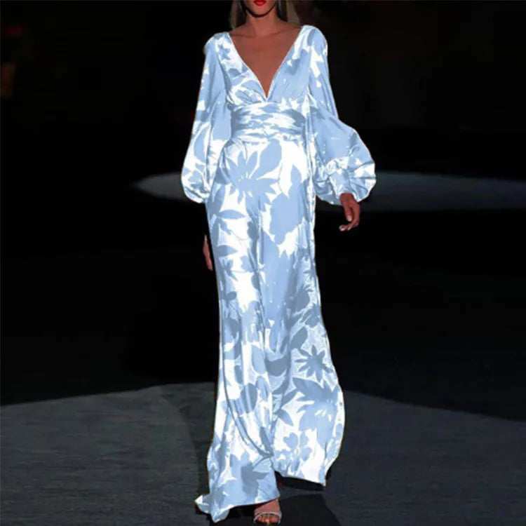 Woman wearing flowing printed maxi dress with deep V-neckline and balloon sleeves in blue floral print