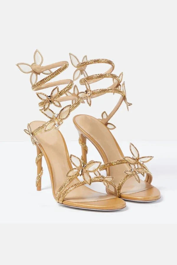 Detail of adjustable lace-up straps and butterfly embellishments on women's occasion heels
