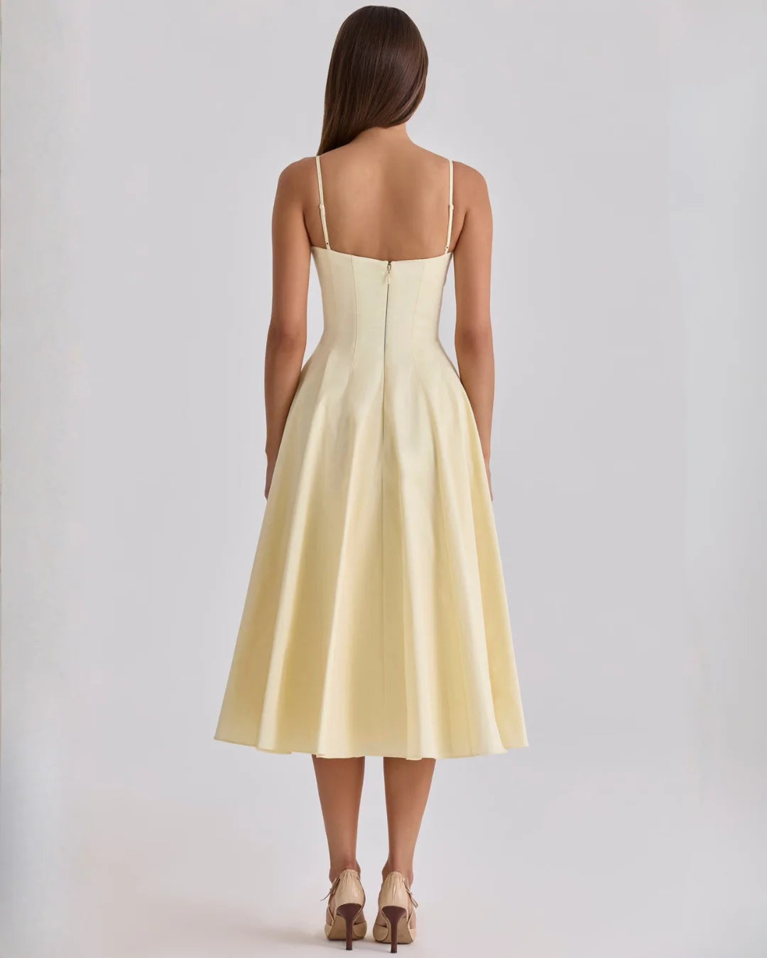 Close-up of twisted bust detail and V-neckline on gathered midi dress