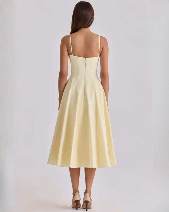 Close-up of twisted bust detail and V-neckline on gathered midi dress
