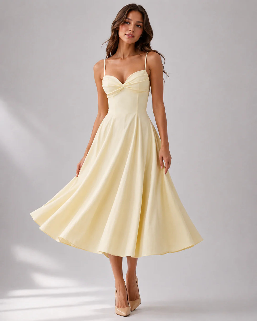 Full-length gathered bust midi dress styled with heeled court shoes for formal occasions