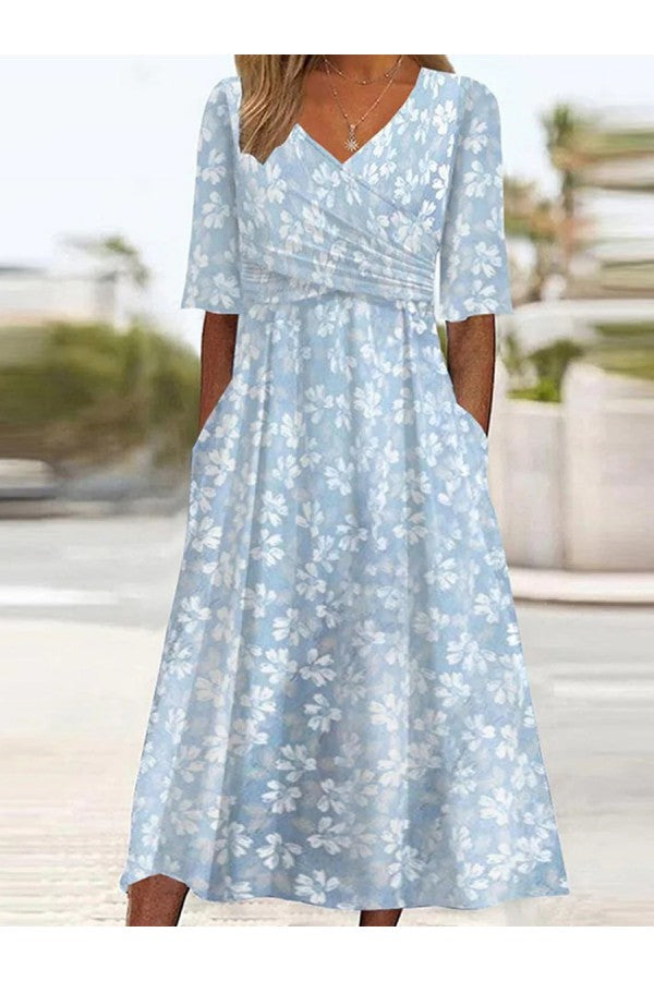 Women's Floral Midi Dress with V-Neckline and Pockets in soft blue with white floral print, featuring wrap bodice and short sleeves