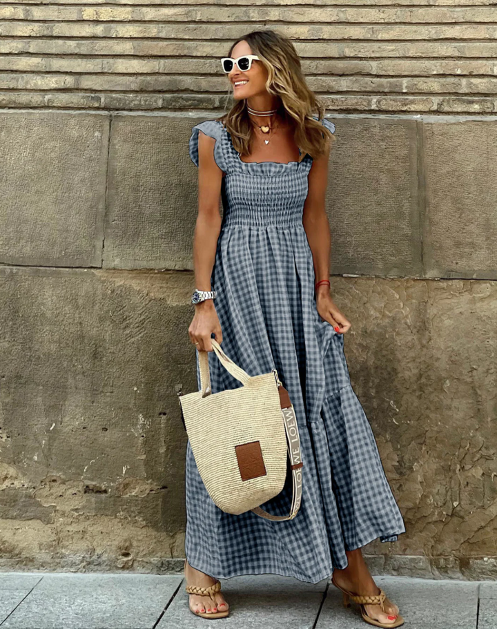 Back view showing ruffled sleeves and flowing tiered hem of smocked summer maxi dress