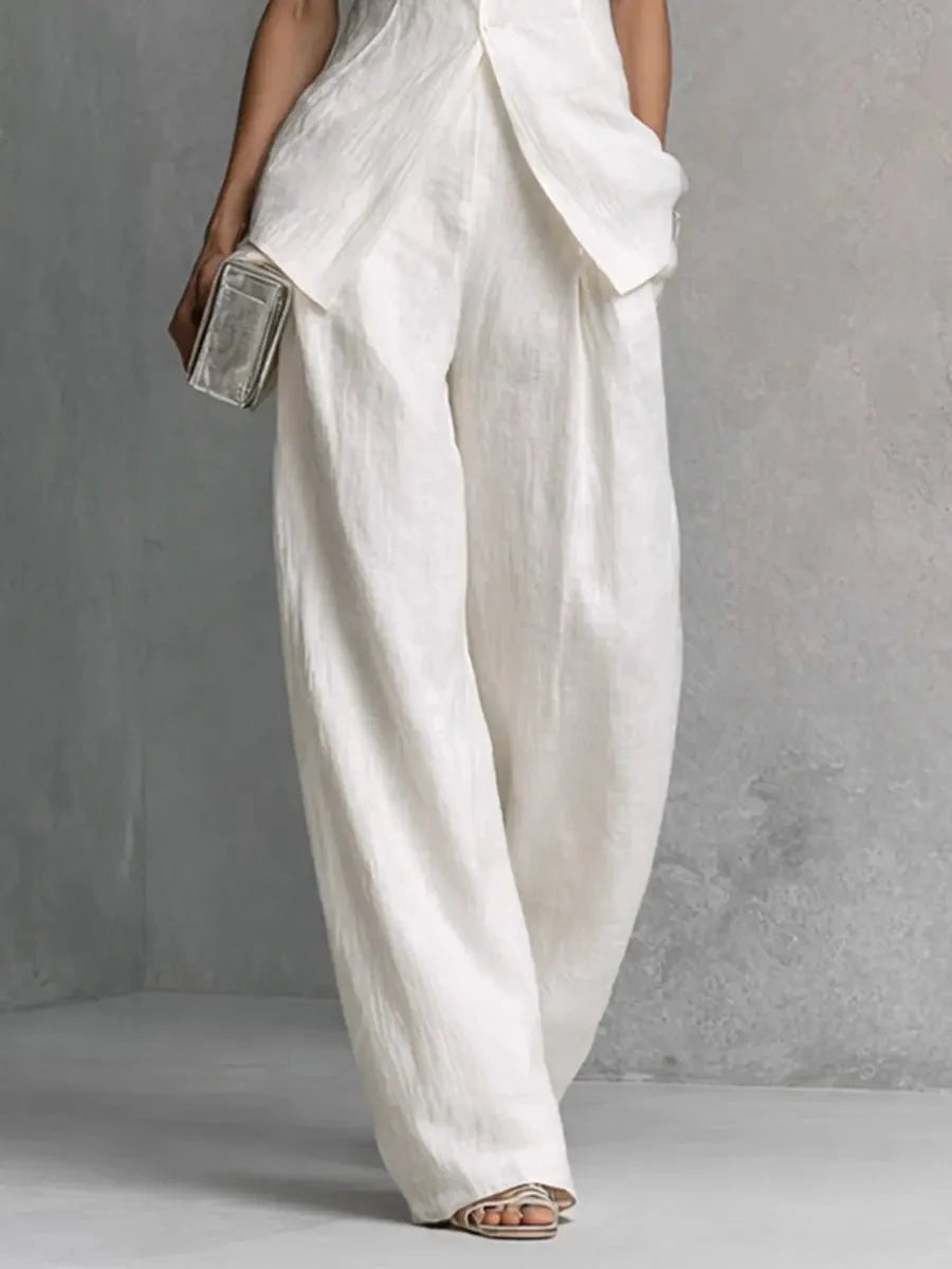 Detail shot of high-waisted wide leg trousers with concealed side pockets and relaxed fit