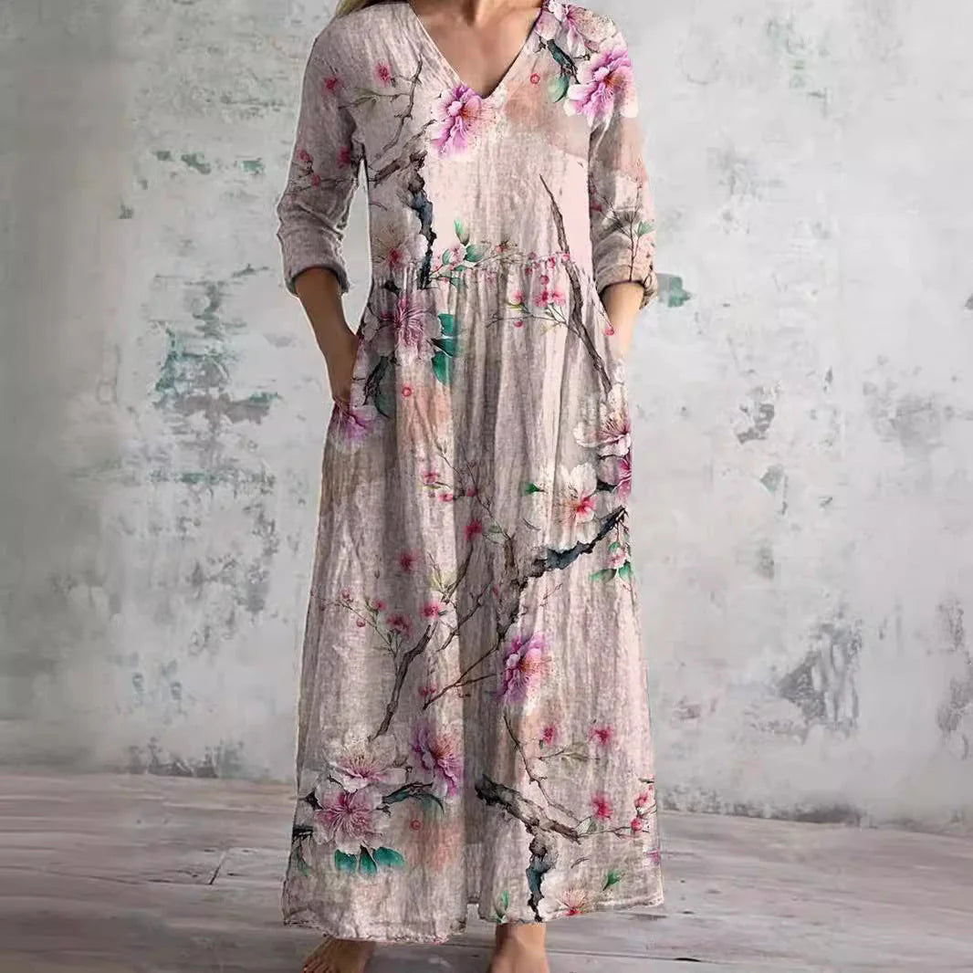 Close-up view of V-neckline and floral print detailing on women's maxi dress with gathered waist