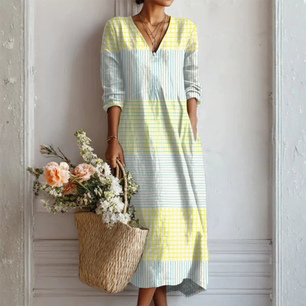 Charlotte wearing the Elegant Crisp Summer Dress in yellow and blue stripes with V-neckline and three-quarter sleeves