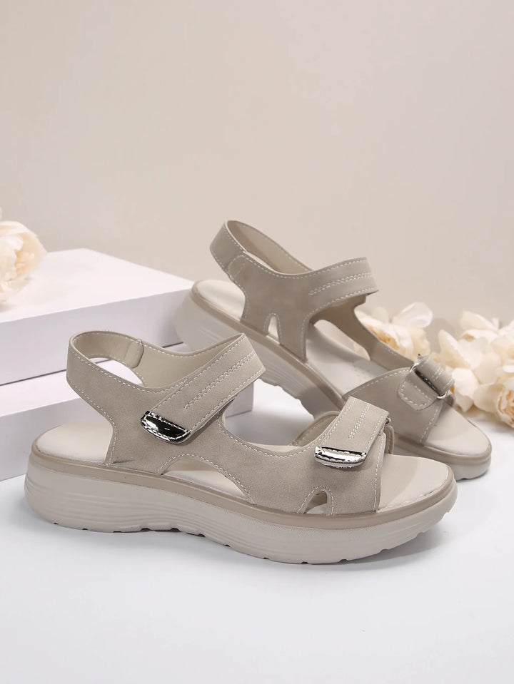 Side profile of orthopaedic sandals featuring wedge sole with ribbed tread pattern for improved grip and stability