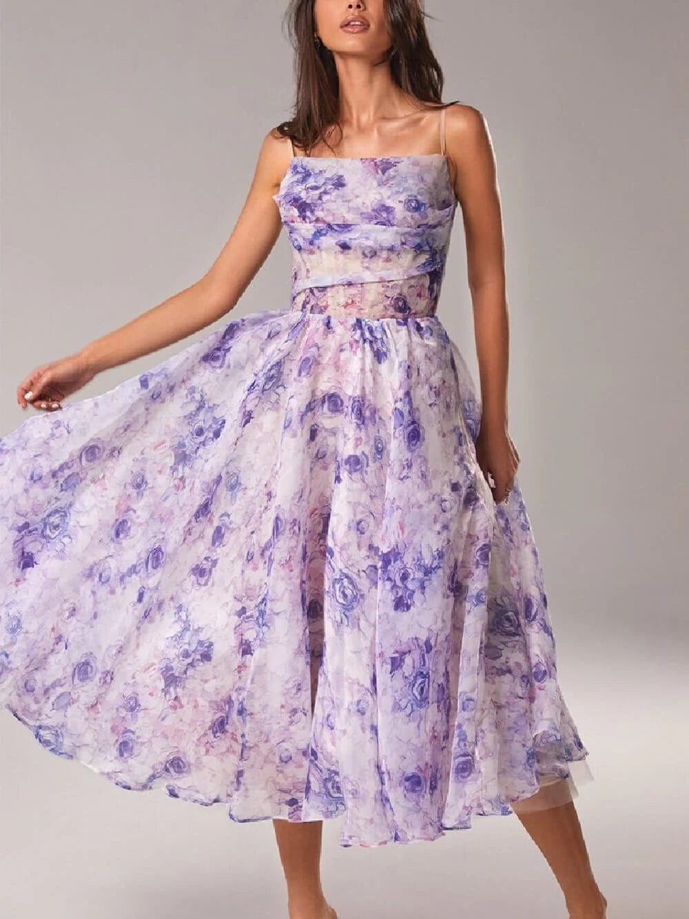 Front view of floral midi dress featuring draped cowl neckline and delicate spaghetti straps with romantic rose pattern