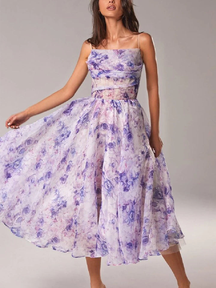 Front view of floral midi dress featuring draped cowl neckline and delicate spaghetti straps with romantic rose pattern