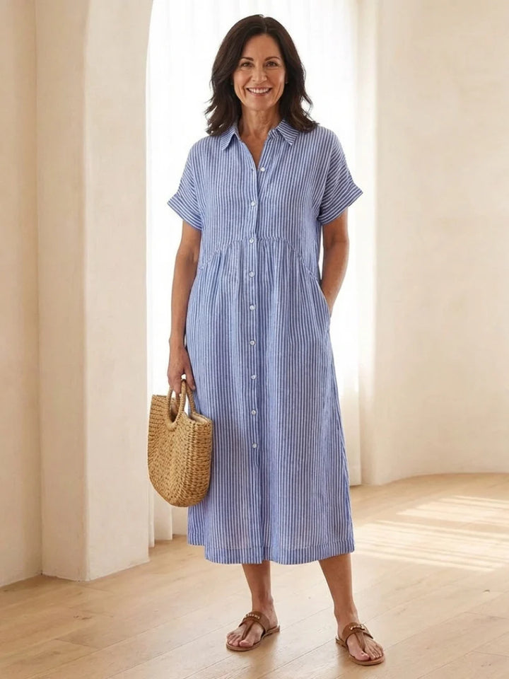 Striped button front short sleeve midi dress with gathered waist and side pockets in blue and white vertical stripes