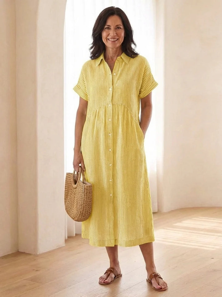 Full length view of striped button front dress with relaxed silhouette and midi hemline