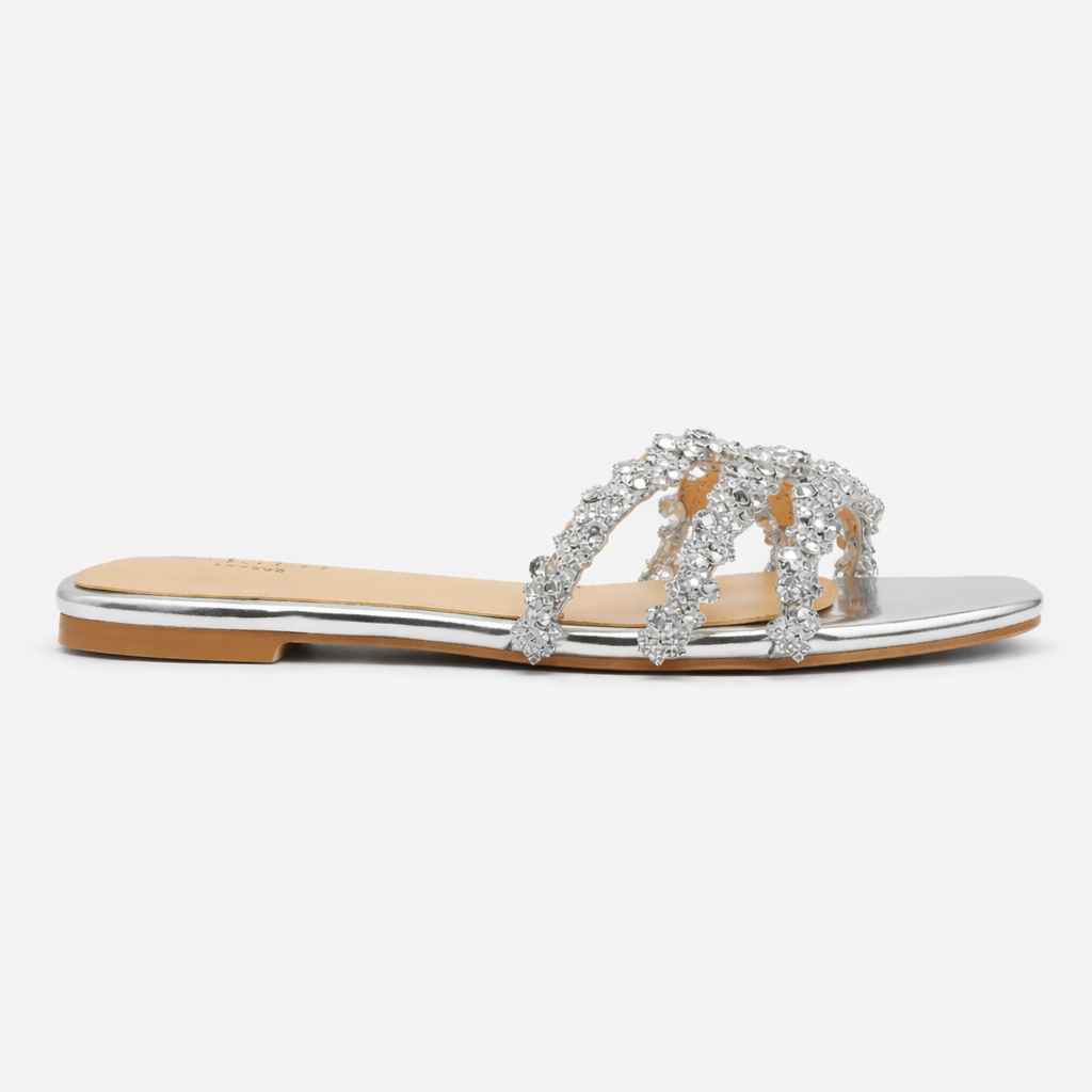 Detail shot of crystal embellishments on women's diamante flat summer sandals