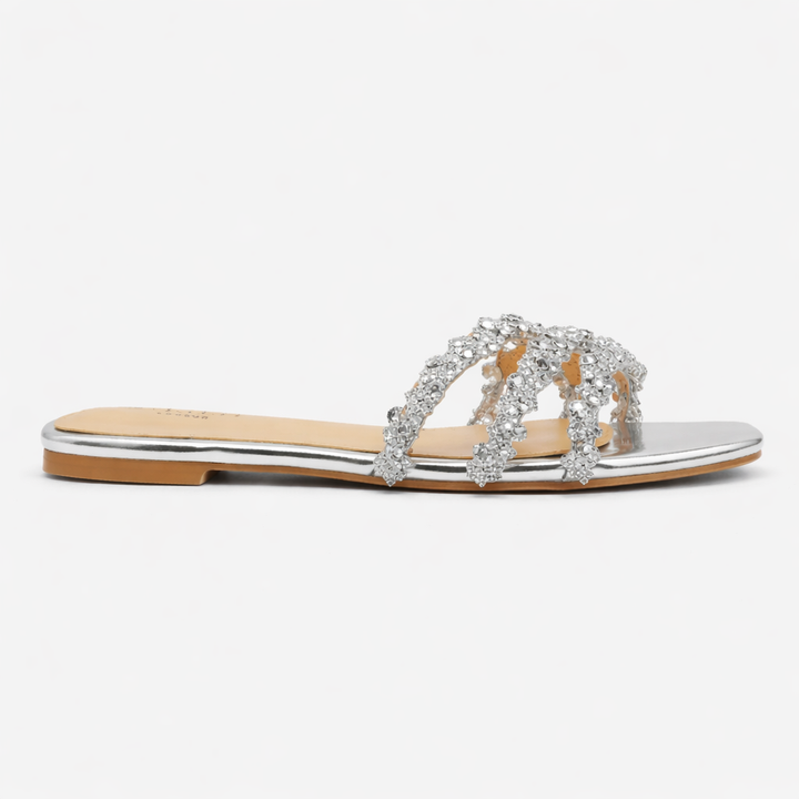 Detail shot of crystal embellishments on women's diamante flat summer sandals