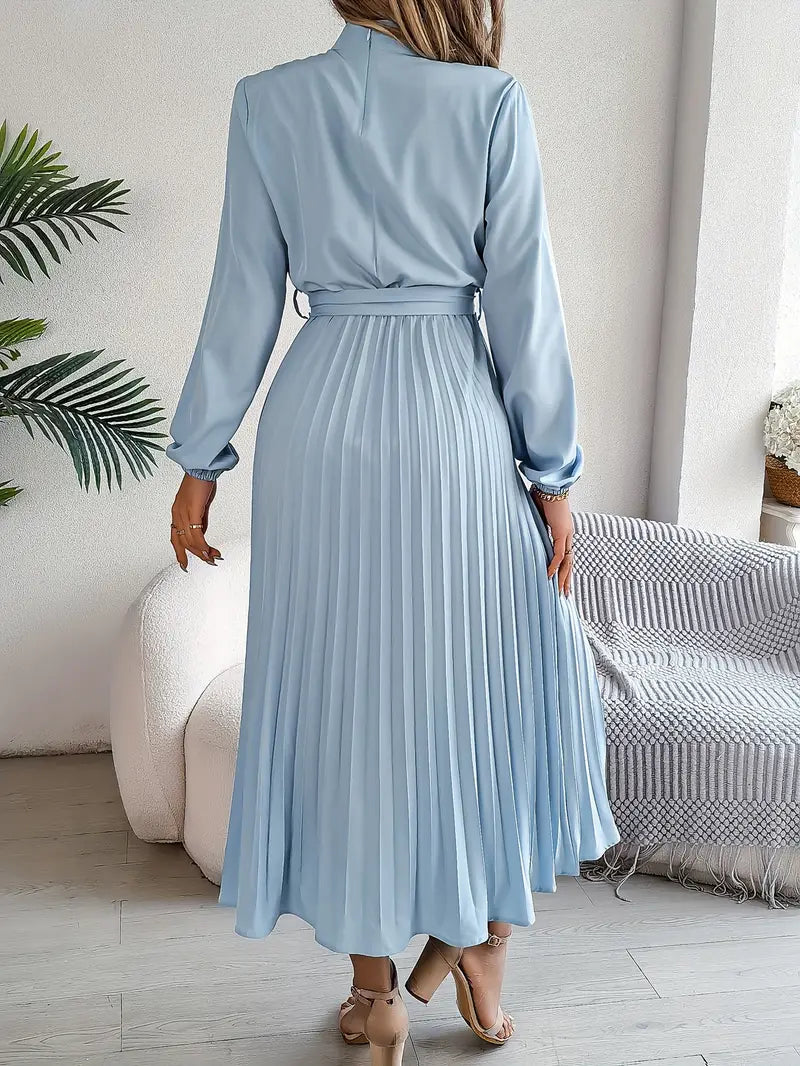 Side view of Women's Long Sleeve Pleated Belted Dress showing flowing pleated skirt and tie belt detail