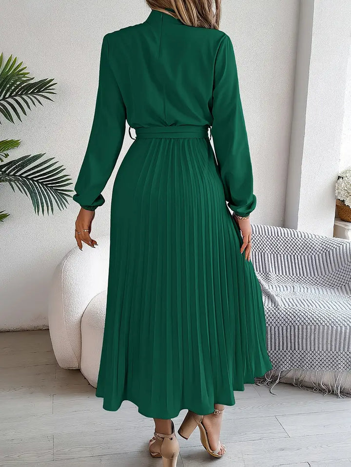 Full-length view of Women's Long Sleeve Pleated Belted Dress with self-tie fabric belt at waist