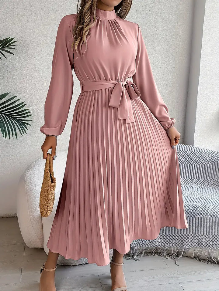 Back view of Women's Long Sleeve Pleated Belted Dress showing pleated skirt movement