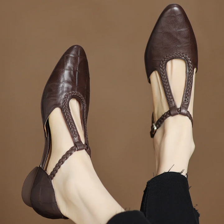Women's Soft Leather Mary Janes in brown with braided T-strap and pointed toe on neutral background