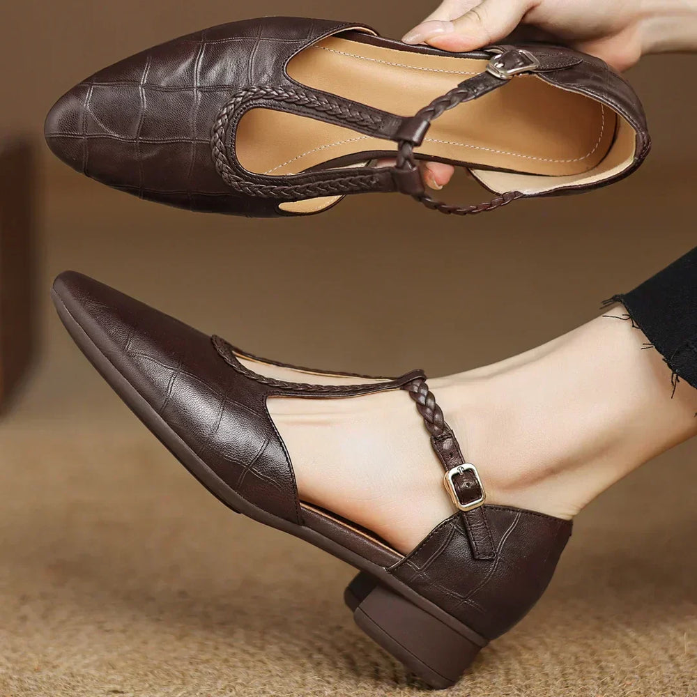 Close-up of brown Soft Leather Mary Janes showing braided T-strap detail and side buckle closure