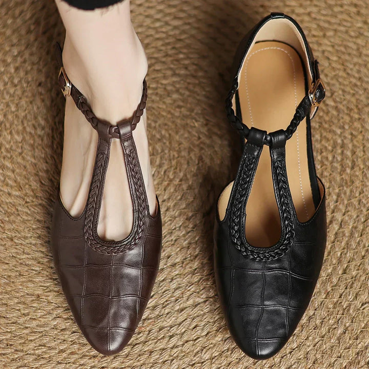 Detail shot of braided leather strap and adjustable buckle on Mary Janes