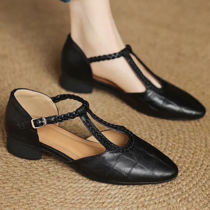 Women's brown Mary Janes on foot showing low heel and comfortable fit