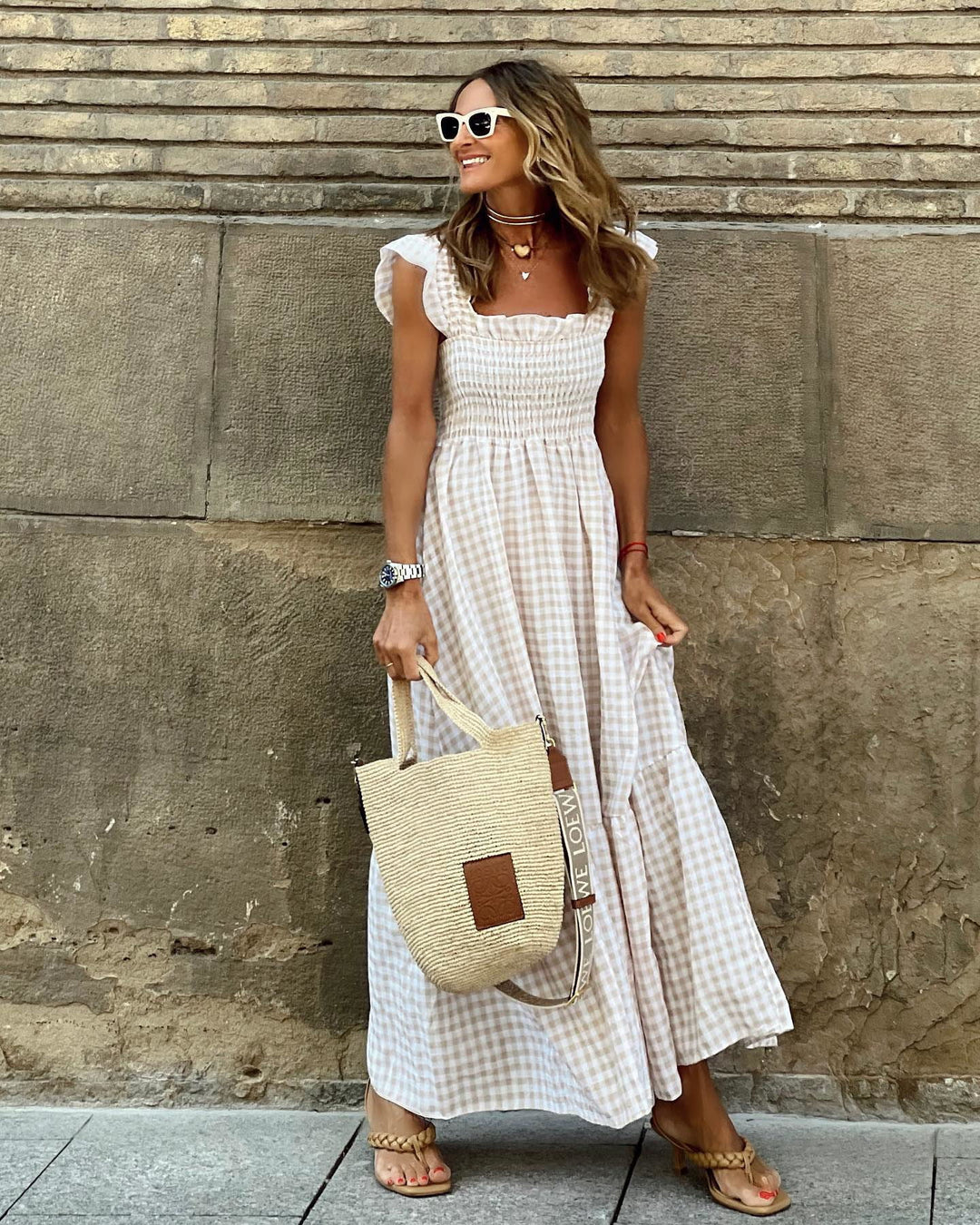 Woman wearing an Elegant Summer Maxi Dress Gingham with smocked bodice and flutter sleeves in beige gingham pattern