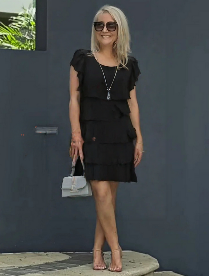 Woman styling the Women's Layered Midi Dress with heels and accessories for a formal occasion