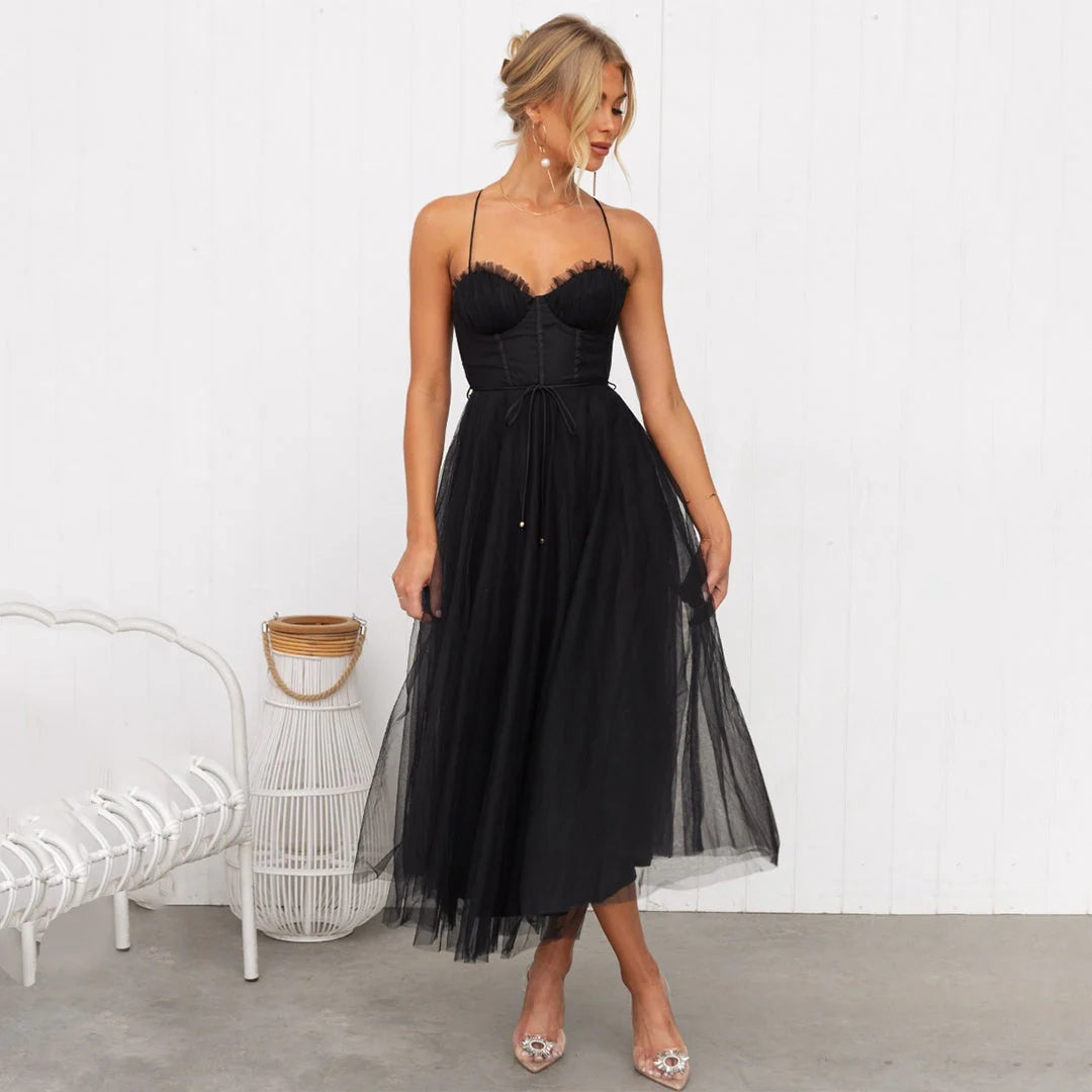 Detail of layered tulle midi skirt with soft drape and mid-calf length hem