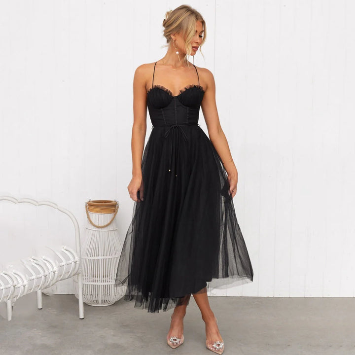 Detail of layered tulle midi skirt with soft drape and mid-calf length hem