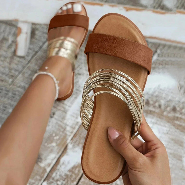Side angle of women's arch support sandals featuring slingback elastic and flat sole construction for all-day wear