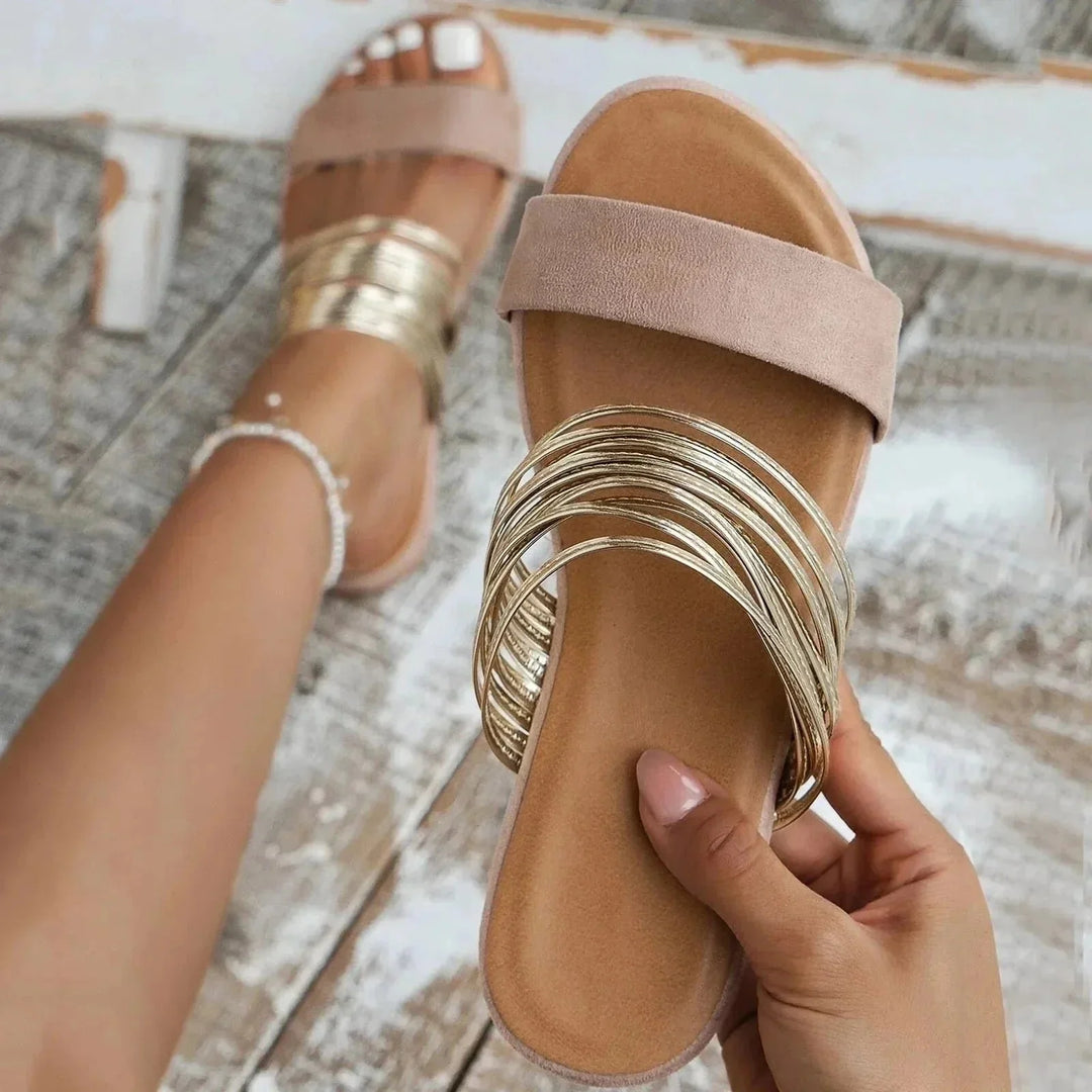 Detail shot of metallic wrapped toe straps on orthopedic sandals with cushioned footbed and anatomical support