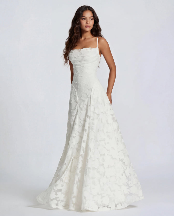 Side view of fitted bodice and flowing skirt on floral lace maxi dress